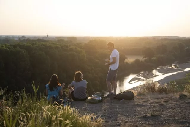 Randonneurs en haut d'un coteau avec vue sur la rivière Le Louet